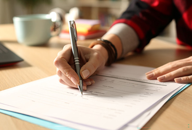 hand filling in paperwork